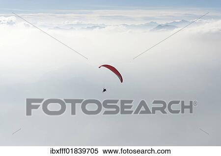 Paragliding above the clouds View Large Photo Image Stock Photography - Paragliding above the clouds. Fotosearch