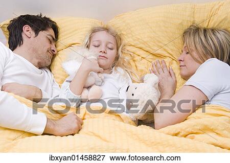 Parents and daughter asleep in bed View Large Photo Image Stock Photo - Parents and daughter asleep in bed. Fotosearch