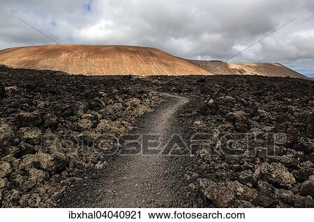 "Path through a lava field, volcanic landscape, Fire Mountains, volcanoes, Caldera Blanca volcano at the back, Lanzarote, Canary Islands, Spain, Europe" View Large Photo Image Stock Image - "Path through a lava field, volcanic landscape, Fire Mountains, volcanoes, Caldera Blanca volcano at the back, Lanzarote, Canary Islands, Spain, Europe". Fotosearch