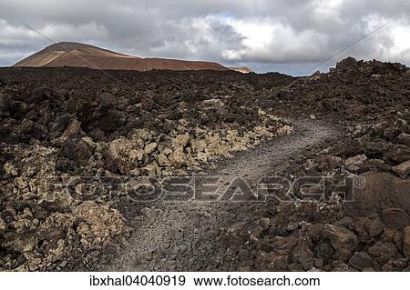 "Path through a lava field, volcanic landscape, Fire Mountains, volcanoes, Caldera Blanca volcano at the back, Lanzarote, Canary Islands, Spain, Europe" View Large Photo Image Stock Photo - "Path through a lava field, volcanic landscape, Fire Mountains, volcanoes, Caldera Blanca volcano at the back, Lanzarote, Canary Islands, Spain, Europe". Fotosearch
