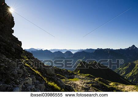 "Peaks of the Allgau Alps in steplike arrangement in the early morning with a sun star, Oberstdorf, Bavaria, Germany, Europe" View Large Photo Image Stock Photography - "Peaks of the Allgau Alps in steplike arrangement in the early morning with a sun star, Oberstdorf, Bavaria, Germany, Europe". Fotosearch