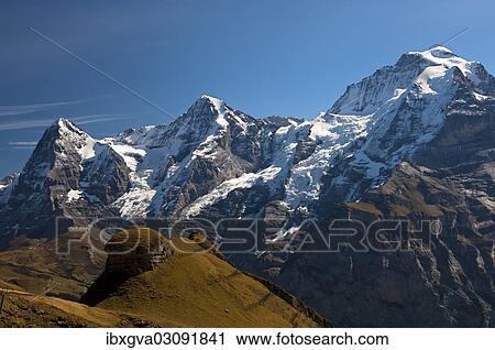Stock Image - "Peaks of the mountains Eiger, Moench and Jungfrau, from left, Bernese Alps, Berner Oberland, Murren, Canton of Bern, Switzerland, Europe". Fotosearch