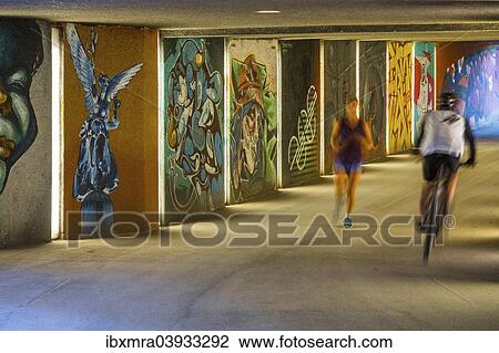 "Pedestrian underpass with graffiti art, with a cyclist and a jogger, Maximilian Park, Munich, Upper Bavaria, Bavaria, Germany, Europe" View Large Photo Image Stock Image - "Pedestrian underpass with graffiti art, with a cyclist and a jogger, Maximilian Park, Munich, Upper Bavaria, Bavaria, Germany, Europe". Fotosearch
