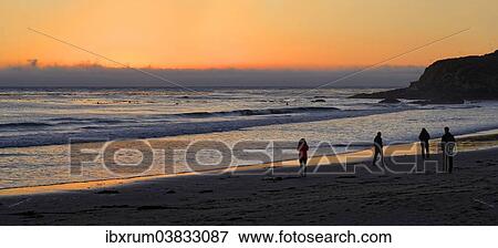 Stock Photo - "People at sunset at the Pacific beach of Cambria, California, United States, North America". Fotosearch