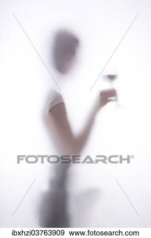 Stock Photo - "Person holding a wine glass, diffused". Fotosearch