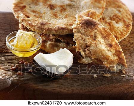 "Peshwari naan bread with coconut, raisins and honey, indian cuisine" View Large Photo Image Stock Image - "Peshwari naan bread with coconut, raisins and honey, indian cuisine". Fotosearch