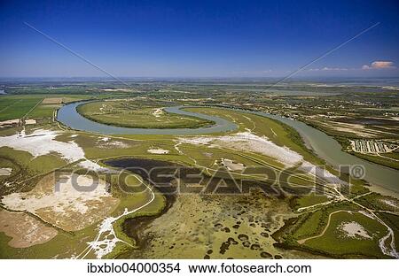 "Petit-Rhone shortly before it joins the Mediterranean Sea, meander, Saintes-Maries-de-la-Mer, Camargue, Provence-Alpes-Cote d'Azur, France, Europe" View Large Photo Image Picture - "Petit-Rhone shortly before it joins the Mediterranean Sea, meander, Saintes-Maries-de-la-Mer, Camargue, Provence-Alpes-Cote d'Azur, France, Europe". Fotosearch