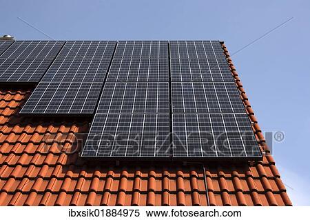 Stock Photography - Photovoltaic system on the roof of a single family detached house. Fotosearch