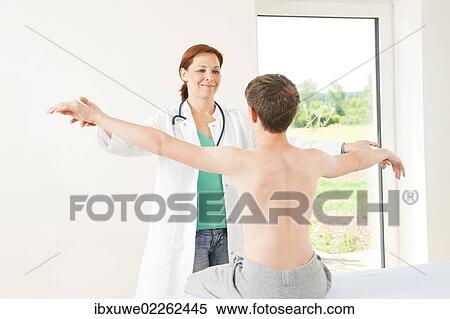 Physiotherapist doing physiotherapy in the shoulder area of a teenage boy View Large Photo Image Stock Photography - Physiotherapist doing physiotherapy in the shoulder area of a teenage boy. Fotosearch