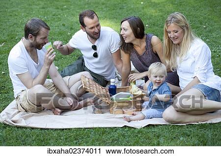 Picnic with friends and a toddler in the park View Large Photo Image Stock Image - Picnic with friends and a toddler in the park. Fotosearch