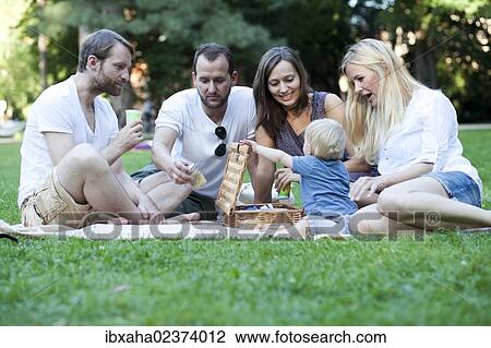 Picnic with friends and a toddler in the park View Large Photo Image Stock Image - Picnic with friends and a toddler in the park. Fotosearch