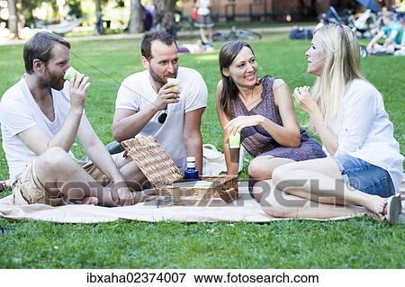 Picnic with friends in the park View Large Photo Image Stock Photo - Picnic with friends in the park. Fotosearch