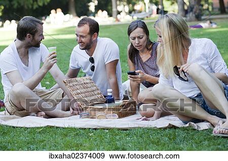 Picnic with friends in the park View Large Photo Image Stock Photo - Picnic with friends in the park. Fotosearch