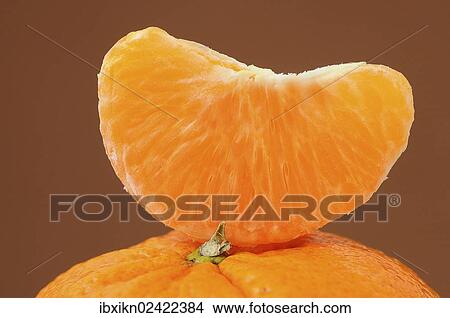 Piece of mandarine on a mandarine View Large Photo Image Picture - Piece of mandarine on a mandarine. Fotosearch