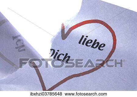 Stock Photo - "Piece of torn paper with the inscription """"Ich liebe dich"""", German for """"I love you""""". Fotosearch