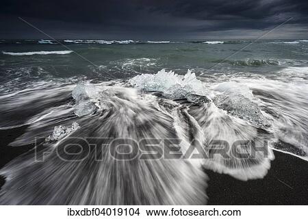 "Pieces of ice on black beach lapped by the sea, at the Jokulsarlon glacier lagoon, Vatnajokull Glacier, Eastern Region, Iceland, Europe" View Large Photo Image Picture - "Pieces of ice on black beach lapped by the sea, at the Jokulsarlon glacier lagoon, Vatnajokull Glacier, Eastern Region, Iceland, Europe". Fotosearch