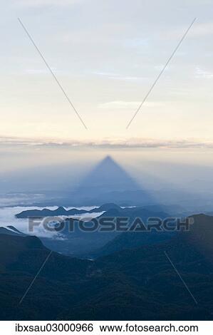 "Pilgrim mountain, sun creating a triangle shadow in the landscape, image of God, Buddhist temple, Adam's Peak, Sri Pada, Dalhousie, Zentrales Hochland, Sri Lanka, Asia" View Large Photo Image Stock Photograph - "Pilgrim mountain, sun creating a triangle shadow in the landscape, image of God, Buddhist temple, Adam's Peak, Sri Pada, Dalhousie, Zentrales Hochland, Sri Lanka, Asia". Fotosearch