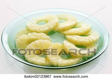 Pineapple slices on a blue glass plate View Large Photo Image Stock Photo - Pineapple slices on a blue glass plate. Fotosearch