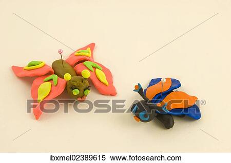 "Plasticine figurines, two butterflies on a pin" View Large Photo Image Stock Photography - "Plasticine figurines, two butterflies on a pin". Fotosearch