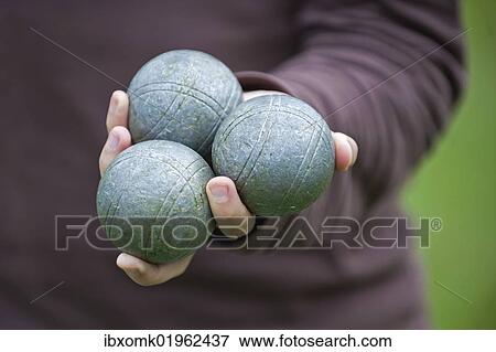 Stock Photo - "Player holding Boules or Petanque balls in his hand, Colmar, France, Europe". Fotosearch
