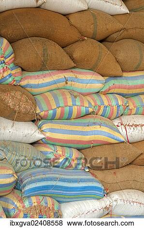 Stock Photo - "Plump bags of rice stacked in a rice warehouse, Battambang, Cambodia, Southeast Asia, Asia". Fotosearch