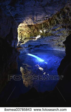 Stock Image - "Poco Encantado cave with light beams, Chapada Diamantina, State of Bahia, Brazil, South America". Fotosearch