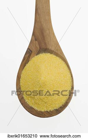 Stock Image - "Polenta, cornmeal on an olive wood spoon". Fotosearch