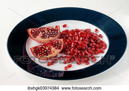 Pomegranate pieces and seeds on a plate View Large Photo Image Picture - Pomegranate pieces and seeds on a plate. Fotosearch