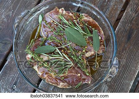 Pork neck steaks in marinade with herbs View Large Photo Image Stock Image - Pork neck steaks in marinade with herbs. Fotosearch