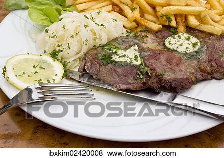 "Pork neck steaks with coleslaw, herb butter and fries" View Large Photo Image Stock Photo - "Pork neck steaks with coleslaw, herb butter and fries". Fotosearch