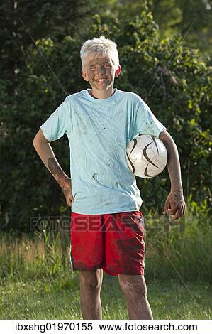 "Portrait of a dirty, smiling boy with a football under his arm" View Large Photo Image Stock Photography - "Portrait of a dirty, smiling boy with a football under his arm". Fotosearch
