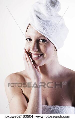 Portrait of a smiling young woman with a towel wrapped around her head View Large Photo Image Picture - Portrait of a smiling young woman with a towel wrapped around her head. Fotosearch