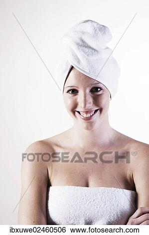 Portrait of a smiling young woman with a towel wrapped around her head View Large Photo Image Stock Photograph - Portrait of a smiling young woman with a towel wrapped around her head. Fotosearch