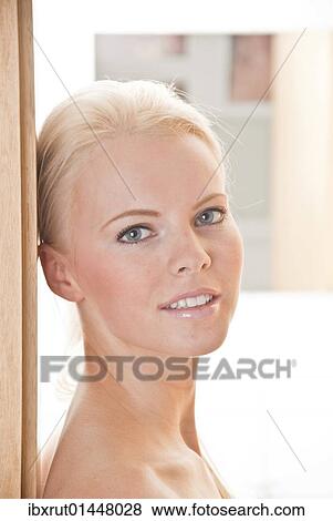 Portrait of a young woman in a doorway View Large Photo Image Stock Photo - Portrait of a young woman in a doorway. Fotosearch