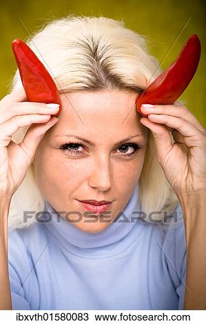 Portrait of a young woman with chilli peppers as horns View Large Photo Image Stock Image - Portrait of a young woman with chilli peppers as horns. Fotosearch