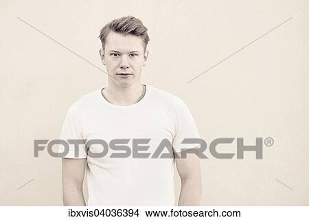 Portrait of young man in front of wall View Large Photo Image Picture - Portrait of young man in front of wall. Fotosearch