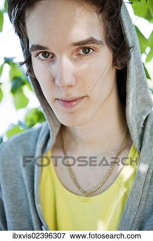 Portrait of young man wearing a hodded sweatshirt View Large Photo Image Stock Photo - Portrait of young man wearing a hodded sweatshirt. Fotosearch