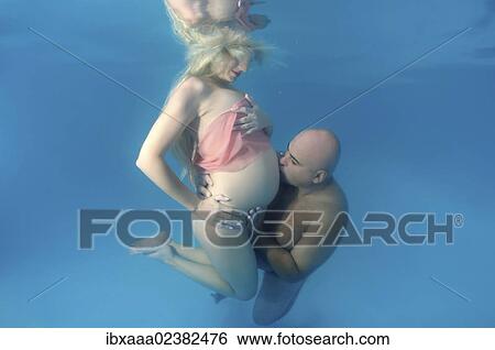 "Pregnant woman and man, underwater fashion in a pool" View Large Photo Image Stock Photograph - "Pregnant woman and man, underwater fashion in a pool". Fotosearch