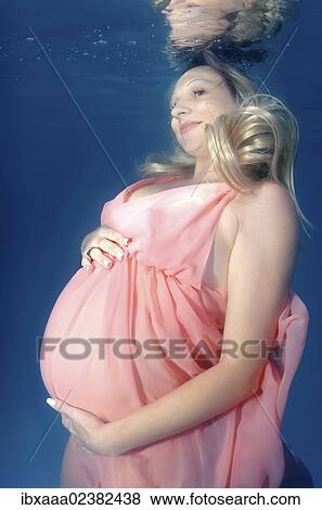 "Pregnant woman, underwater fashion in a pool" View Large Photo Image Stock Photo - "Pregnant woman, underwater fashion in a pool". Fotosearch