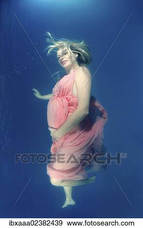 "Pregnant woman, underwater fashion in a pool" View Large Photo Image Stock Photo - "Pregnant woman, underwater fashion in a pool". Fotosearch