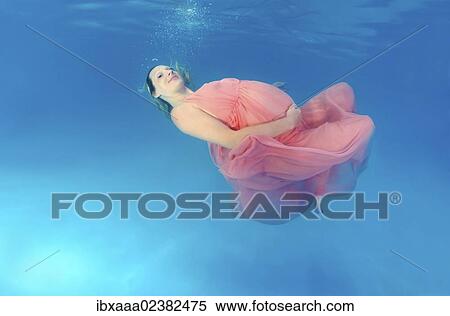 "Pregnant woman, underwater fashion in a pool" View Large Photo Image Stock Photography - "Pregnant woman, underwater fashion in a pool". Fotosearch