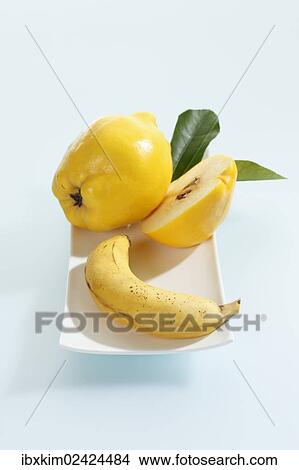Quince and banana on a porcelain plate View Large Photo Image Picture - Quince and banana on a porcelain plate. Fotosearch