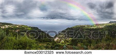 Stock Photography - "Rainbow above the cliffs at Arco de Sao Jorge, Sao Jorge, Funchal, Madeira, Portugal, Europe". Fotosearch