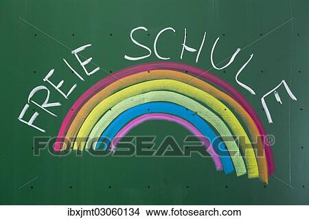 Picture - "Rainbow and """"Freie Schule"""", German for an alternative school written with chalk on a blackboard, Germany, Europe". Fotosearch