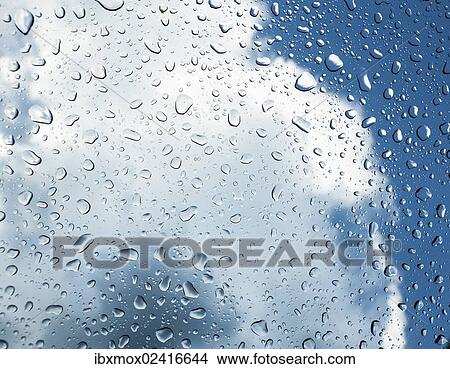 Raindrops on a window in front of storm clouds View Large Photo Image Picture - Raindrops on a window in front of storm clouds. Fotosearch