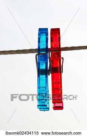 Red and blue pegs on a clothesline View Large Photo Image Stock Photography - Red and blue pegs on a clothesline. Fotosearch