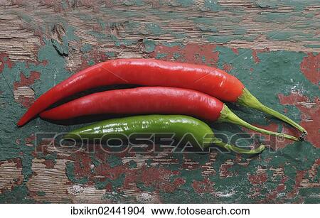 Red and green peppers on an old wooden board View Large Photo Image Picture - Red and green peppers on an old wooden board. Fotosearch