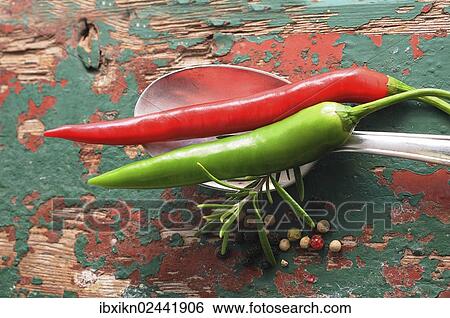 Red and green peppers with a spoon on an old wooden board View Large Photo Image Stock Photograph - Red and green peppers with a spoon on an old wooden board. Fotosearch