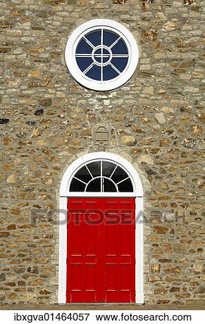 "Red door and white round window of the Saint-Pierre-et-Saint-Paul Church, historic monument in the town of St-Pierre-de-l'Ile-d'Orleans, on Orleans Island, Quebec, Canada, North America" View Large Photo Image Stock Photo - "Red door and white round window of the Saint-Pierre-et-Saint-Paul Church, historic monument in the town of St-Pierre-de-l'Ile-d'Orleans, on Orleans Island, Quebec, Canada, North America". Fotosearch