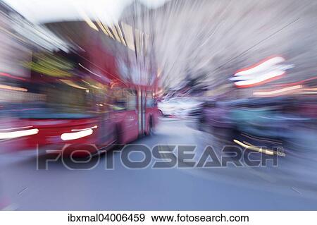 Stock Photo - "Red double decker bus, motion blur, Piccadilly Circus tube station, London, England, United Kingdom, Europe". Fotosearch